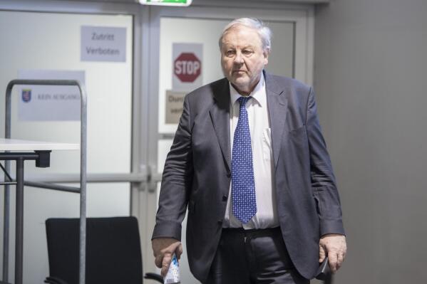The defendant in the Cum-Ex trial, Hanno Berger, enters the provisional courtroom for the announcement of the verdict in Wiesbaden, Germany, Tuesday, May 30, 2023. A central figure in a German tax evasion scandal has been convicted in a related case and sentenced to more than eight years in prison. The Wiesbaden state court convicted German lawyer Hanno Berger of three counts of tax evasion and gave him a sentence of eight years and three months. (Helmut Fricke/DPA via AP, Pool)