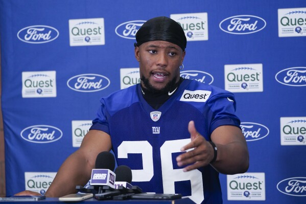 New York Giants' Saquon Barkley talks to reporters after a practice at the NFL football team's training facility in East Rutherford, N.J., Thursday, July 27, 2023. (AP Photo/Seth Wenig)