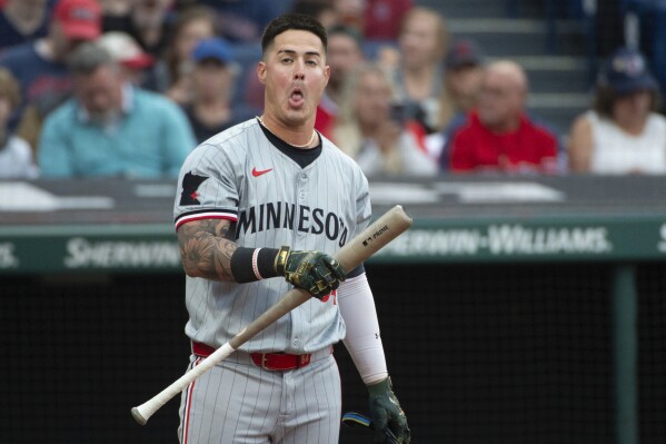 Minnesota Twins' Jose Miranda reacts between pitches from Cleveland Guardians starter Triston McKenzie during the third inning of a baseball game in Cleveland, Friday, May 17, 2024. (AP Photo/Phil Long)