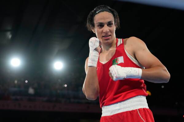 Algeria's Imane Khelif poses after defeating China's Yang Liu to win gold in their women's 66 kg final boxing match at the 2024 Summer Olympics, Friday, Aug. 9, 2024, in Paris, France. (AP Photo/Ariana Cubillos, File)
