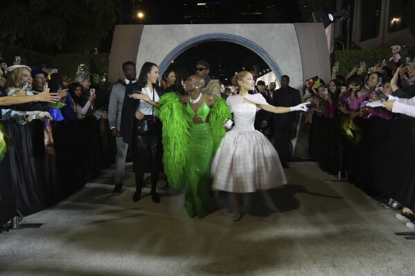 FILE - Cynthia Erivo, left, and Ariana Grande arrive at the premiere of "Wicked" on Saturday, Nov. 9, 2024, at Dorothy Chandler Pavilion in Los Angeles. In “Wicked,” Elphaba and Glinda travel from Shiz University to the Emerald City on a glistening green train to meet the wizard. In real life, Cynthia Erivo and Ariana Grande have traveled much farther and wider and longer and on airplanes to promote their hotly anticipated film. (Photo by Jordan Strauss/Invision/AP, File)