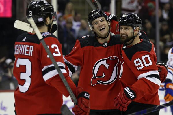 New Jersey Devils center Dawson Mercer, center, reacts after scoring a goal against the Edmonton Oilers during the second period of an NHL hockey game Monday, Nov. 21, 2022, in Newark, N.J. (AP Photo/Adam Hunger)