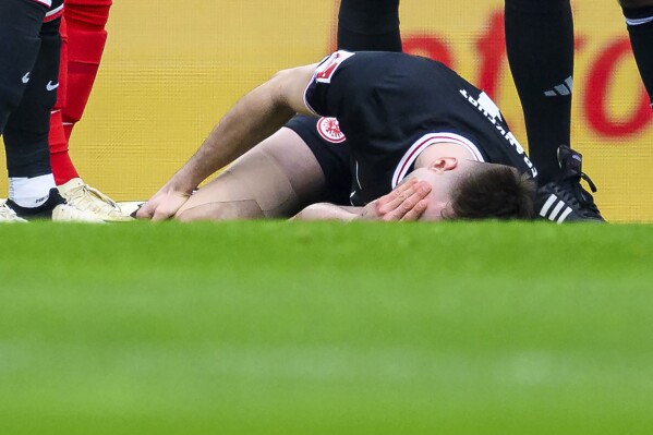 Frankfurt's Sasa Kalajdzic lies injured during the German Bundesliga soccer match between Freiburg and Eintracht Frankfurt at the Europa-Park Stadium in Freiburg, Germany, Sunday, Feb. 18, 2024. Eintracht Frankfurt forward Sasa Kalajdzic has been ruled out of action for months after tearing the cruciate and lateral ligaments in his right knee. (Tom Weller/dpa via AP)