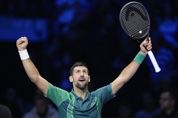 Serbia's Novak Djokovic reacts after defeating Spain's Carlos Alcaraz in their singles semifinal tennis match of the ATP World Tour Finals at the Pala Alpitour, in Turin, Italy, Saturday, Nov. 18, 2023. (AP Photo/Antonio Calanni)