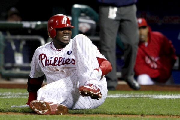 FILE - Philadelphia Phillies' Ryan Howard reacts after falling down injured on his way to first base as he makes the last out during the ninth inning of Game 5 of the National League division baseball series against the St. Louis Cardinals, in Philadelphia, Oct. 7, 2011. For 11 years, Howard’s groundout in the season’s final at-bat served as a flashpoint for a franchise that briefly ruled the NL East, only to fall into a chasm of bad baseball and meaningless Septembers. The Philadelphia Phillies are set to play their first home playoff game since 2011. (AP Photo/Alex Brandon, File)