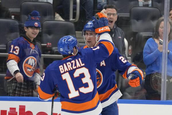 New York Islanders center Brock Nelson (29) celebrates after scoring against the Pittsburgh Penguins with center Mathew Barzal (13) during the second period of an NHL hockey game Friday, Feb. 17, 2023, in Elmont, N.Y. (AP Photo/Mary Altaffer)