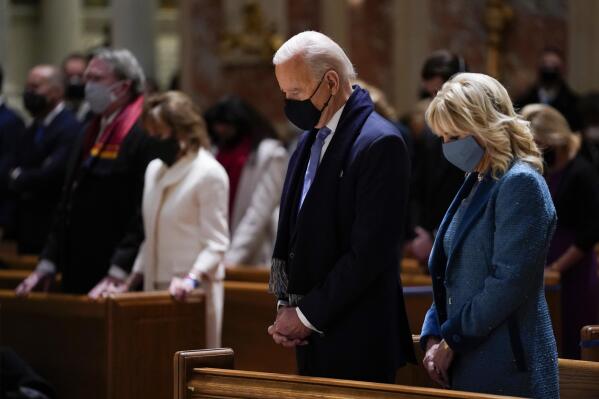 FILE - In this Wednesday, Jan. 20, 2021 file photo, President-elect Joe Biden and his wife, Jill Biden, attend Mass at the Cathedral of St. Matthew the Apostle during Inauguration Day ceremonies in Washington. When U.S. Catholic bishops hold their next national meeting in June 2021, they’ll be deciding whether to send a tougher-than-ever message to President Joe Biden and other Catholic politicians: Don’t partake of Communion if you persist in public advocacy of abortion rights. (AP Photo/Evan Vucci)