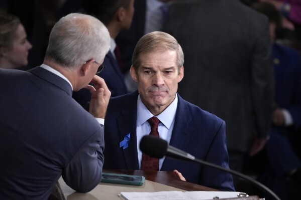 Rep. Jim Jordan, R-Ohio, right, confers with Rep. Patrick McHenry, R-N.C., the temporary leader of the House of Representatives, as the House convenes for a second day of balloting to elect a speaker, at the Capitol in Washington, Wednesday, Oct. 18, 2023. (AP Photo/J. Scott Applewhite)