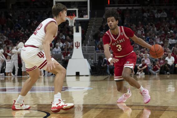 Miami (Ohio) guard Julian Lewis (3) dribbles around Indiana forward Miller Kopp (12) during the first half of an NCAA college basketball game, Sunday, Nov. 20, 2022, in Indianapolis. (AP Photo/Marc Lebryk)