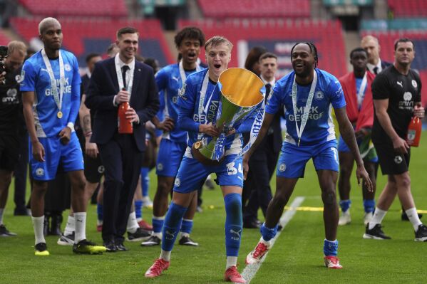 Peterborough United's Harley Mills with the trophy after winning the Vertu Trophy Final at Wembley Stadium, London, Sunday April 13, 2025. (Bradley Collyer/PA via AP)