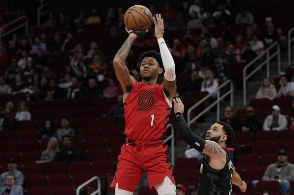 Portland Trail Blazers guard Anfernee Simons (1) scores as Houston Rockets guard Fred VanVleet looks on during the first quarter of an NBA basketball game, Wednesday, Jan. 24, 2024, in Houston. (AP Photo/Kevin M. Cox)