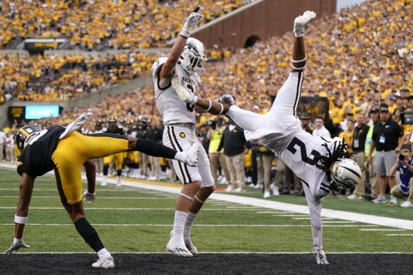 Western Michigan cornerback Keni-H Lovely (2) intercepts a pass intended for Iowa wide receiver Seth Anderson, left, in the end zone during the first half of an NCAA college football game, Saturday, Sept. 16, 2023, in Iowa City, Iowa. Western Michigan safety Tate Hallock (3) looks on. (AP Photo/Charlie Neibergall)