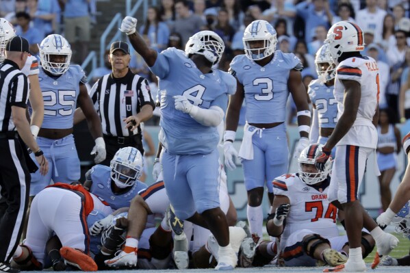 North Carolina defensive lineman Travis Shaw (4) celebrates after a play during the second half of an NCAA college football game against Syracuse, Saturday, Oct. 7, 2023, in Chapel Hill, N.C. (AP Photo/Chris Seward)