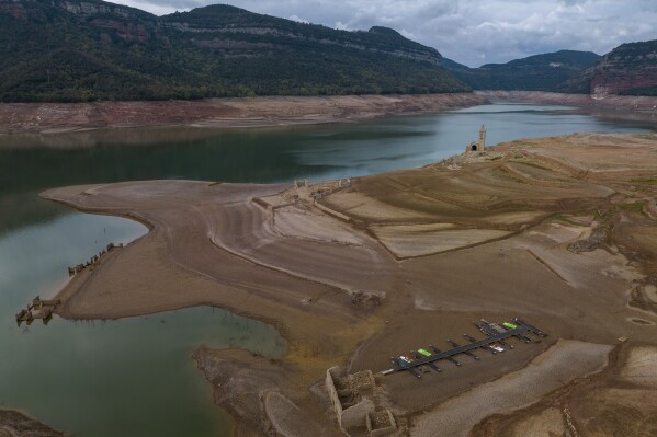 FILE - View of the Sau reservoir, about 100 km (62 miles) north of Barcelona, Spain, Tuesday, April 18, 2023. Spain’s Catalonia region declared a drought emergency in 24 municipalities Wednesday, Aug. 2, 2023, following a severe lack of rain in recent years. (AP Photo/Emilio Morenatti, File)