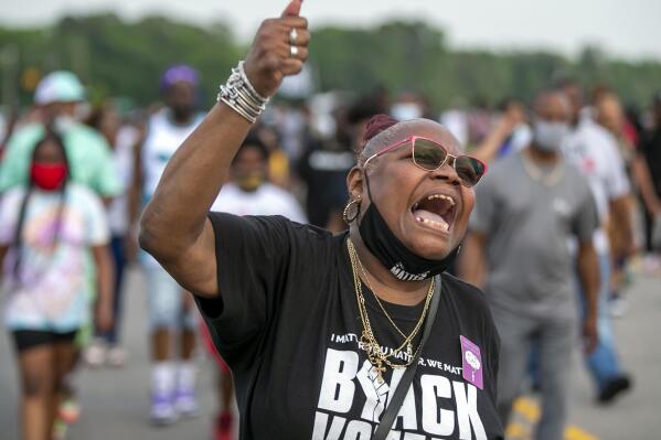 Celeste Taylor chants as she leads demonstrators on Halstead Avenue in Elizabeth City, N.C., Thursday, April 29, 2021. This is the ninth day of demonstrations in the wake of Andrew Brown Jr.'s death at the hands of Pasquotank County deputies. (Robert Willett/The News & Observer via AP)
