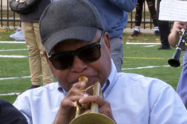 In this image made from video, Wynton Marsalis plays the trumpet during a rehearsal with the Michigan Marching Band on Thursday, Oct. 13, 2022, in Ann Arbor, Mich. The Grammy and Pulitzer winner is taking part in a week-long residency at the University of Michigan. (AP Photo/Mike Householder)