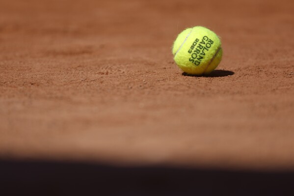 FILE - A ball rests on the court of the French Open tennis tournament at the Roland Garros stadium in Paris, Saturday, June 3, 2023. (AP Photo/Jean-Francois Badias, File)