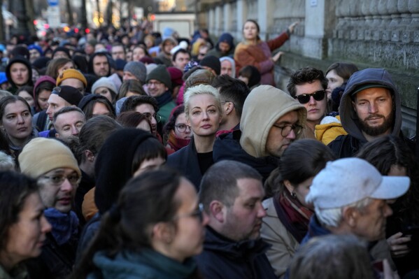 Yulia Navalnaya, center, widow of Alexey Navalny, stands in a queue with other voters at a polling station near the Russian embassy in Berlin, after noon local time, on Sunday, March 17, 2024. (AP Photo/Ebrahim Noroozi)
