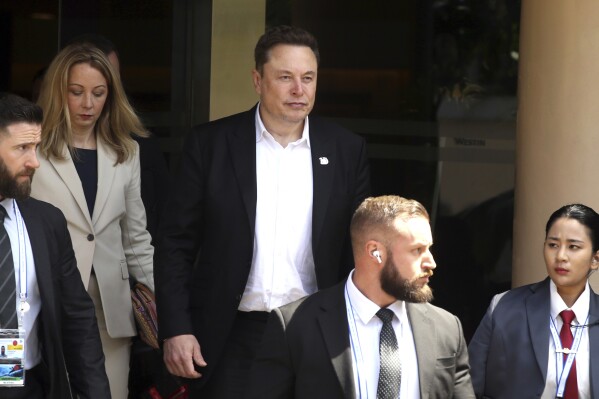 Elon Musk, center, arrives for the 10th World Water Forum in Nusa Dua, Bali, Indonesia on Monday, May 20, 2024. (AP Photo/Firdia Lisnawati)