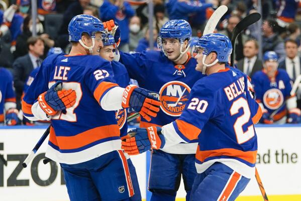 New York Islanders' Anders Lee (27) and Kieffer Bellows (20) celebrate with teammates after Lee scored a goal during the second period of an NHL hockey game against the Buffalo Sabres Thursday, Dec. 30, 2021, in Elmont, N.Y. (AP Photo/Frank Franklin II)