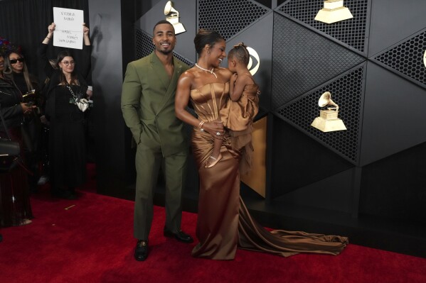 John Gaines, from left, Victoria Monet, and Hazel Monet Gaines arrive at the 66th annual Grammy Awards on Sunday, Feb. 4, 2024, in Los Angeles. (Photo by Jordan Strauss/Invision/AP)