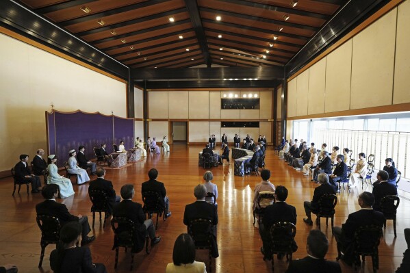 Japan's Emperor Naruhito and Empress Masako, along with other imperial family members, on the left side, attend an annual celebration of poetry at the Imperial Palace in Tokyo, Friday, Jan. 19, 2024. Japanese imperial family members read poetry with guests at the palace to welcome the new year. (Yohei Fukai/Kyodo News via AP)