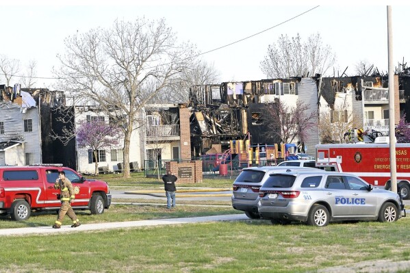 Law enforcement and emergency personnel work at scene following a a fire in an apartment building complex Thursday, March 21, 2024, in Chanute, Kan. (Richard Luken/Iola Register via AP)
