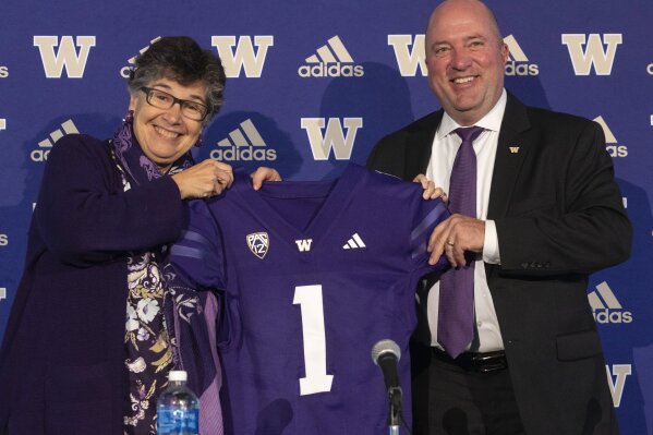 University of Washington President Ana Mari Cauce introduces new UW Athletic Director Troy Dannen during a news conference, Tuesday, Oct. 10, 2023 in Seattle. (Ken Lambert/The Seattle Times via AP)