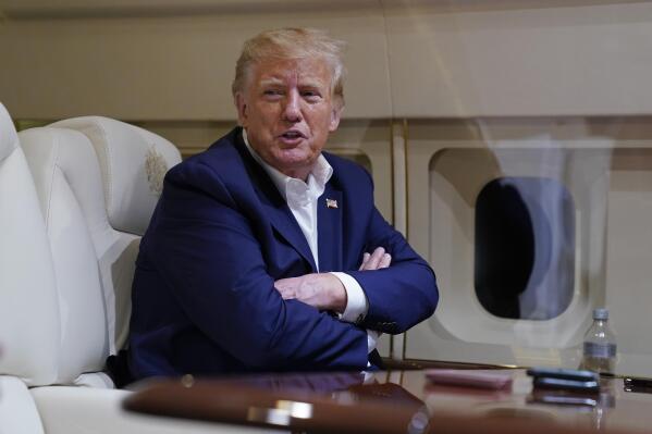 FILE - Former President Donald Trump speaks with reporters while in flight on his plane after a campaign rally at Waco Regional Airport, in Waco, Texas, March 25, 2023, while en route to West Palm Beach, Fla. As Trump rails against possible indictment in New York, his team is leaning into a strategy that has quietly become a become a cornerstone of his campaign: releasing made-for-social media videos reacting to the news and outlining his agenda for a second term. (AP Photo/Evan Vucci)