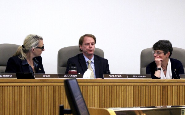FILE - Oregon Senate Republican Leader Sen. Tim Knopp, center, seats between Senate Majority Leader Kate Lieber, left, and Democratic Sen. Elizabeth Steiner during a hearing, Tuesday, June 13, 2023, of the Senate Committee on Rules in Salem, Ore. Enough Republicans members showed up in the Oregon Senate on Thursday, June 15, to end a six-week walkout that halted the work of the legislature and blocked hundreds of bills, including some on abortion, transgender health care and gun safety. (AP Photo/Andrew Selsky, File)