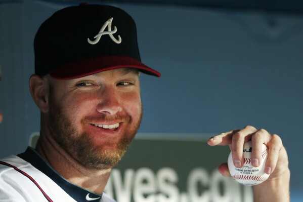 FILE - Atlanta Braves relief pitcher Jonny Venters sits on the bench during a baseball game against the Miami Marlins in Atlanta, Monday, July 21, 2014. Pitchers can look to Jonny Venters as they return from a second operation to repair a torn elbow ligament: He made it back to the big leagues after what he calls 3 1/2 Tommy John procedures. (AP Photo/John Bazemore, File)