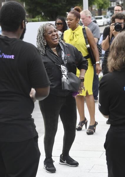 Martha Reeves of Martha and the Vandellas dances to Motown music playing at the Motown Museum. The museum celebrates the completion of two of three phases of an ambitious expansion plan, including a new courtyard in front of the museum, during a gathering in Detroit, Monday, August 8, 2022. (Daniel Mears/Detroit News via AP)