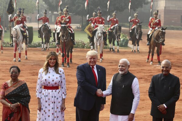 Indian Prime Minister Narendra Modi shakes hand with U.S. President Donald Trump, with first lady Melania Trump, second left, Indian President Ram Nath Kovind, right, and his wife Savita Kovind standing beside them during a ceremonial welcome for Trump at the Indian Presidential Palace in New Delhi, India, Tuesday, Feb. 25, 2020. (AP Photo/Manish Swarup)