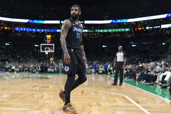 Dallas Mavericks guard Kyrie Irving heads toward the bench during the first half of Game 1 of the basketball team's NBA Finals against the Boston Celtics, Thursday, June 6, 2024, in Boston. (AP Photo/Charles Krupa)