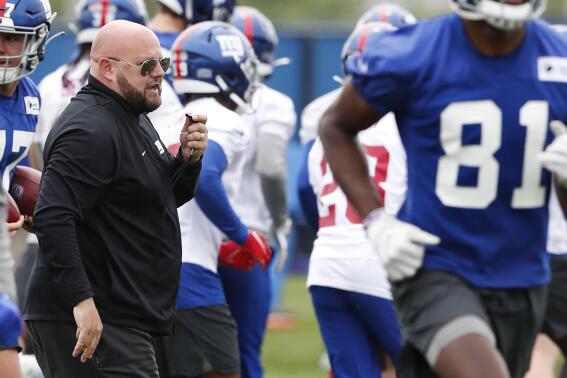 New York Giants head coach Brian Daboll participates in drills at the NFL football team's rookie minicamp in East Rutherford, N.J., Friday, May 13, 2022. (AP Photo/Noah K. Murray)