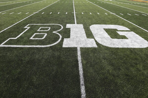 FILE - The Big Ten logo is displayed on the field before an NCAA college football game between Iowa and Miami of Ohio in Iowa City, Iowa., Aug. 31, 2019. Dealing a crushing combination to the Pac-12 on Friday, Aug. 4, 2023, the Big Ten announced Oregon and Washington would be joining the conference next August, and the Big 12 completed its raid of the beleaguered league by adding Arizona, Arizona State and Utah. (AP Photo/Charlie Neibergall, File)