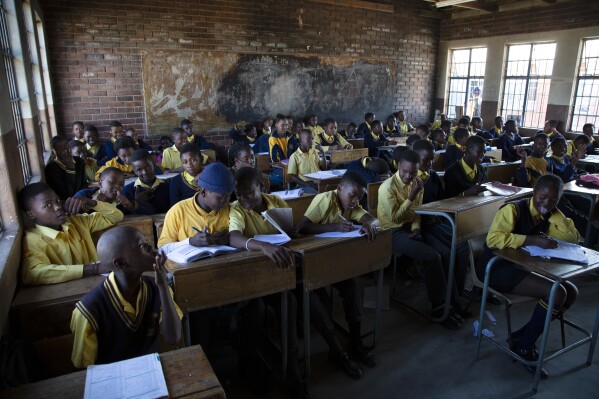 Students attend a class at the Seipone Secondary School in the rural village of Ga-Mashashane, near Polokwane, South Africa, Thursday May 4, 2023. Human rights groups have been pressuring the government for a decade to get rid of pit toilets in schools, with the issue given added urgency by several tragic cases of young children falling into the pits and drowning. (AP Photo/Denis Farrell)