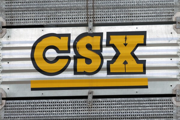 FILE - The CSX logo is seen, July 15, 2013, Nashville, Tenn. A railroad worker was crushed to death between two railcars early Sunday, Sept. 17, 2023, by a remote-controlled train in a CSX railyard in Ohio, raising concerns among unions about such technology. (AP Photo/Mark Humphrey, File)