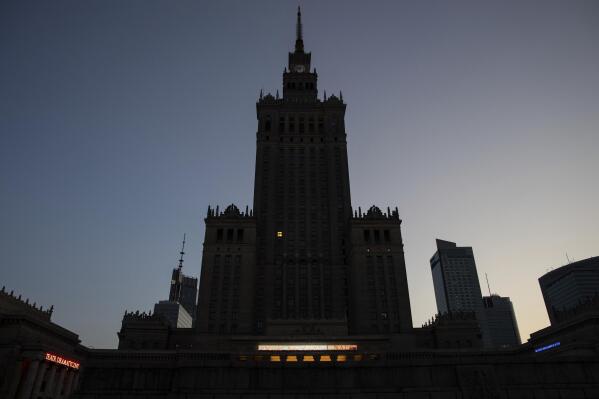 The Palace of Culture and Science is seen at dusk in Warsaw, Poland, Saturday, Aug. 27, 2022. The Palace of Culture, a Stalin-era skyscraper in the center of Warsaw remains a prominent reminder of the communist era and Soviet domination. The building was a gift from dictator Josef Stalin and was long seen as a symbol of communism. When communism fell more than 30 years ago, some called for it to be torn down. But it is a part of a city's life and has since received protection status as a place of historical significance. (AP Photo/Michal Dyjuk)