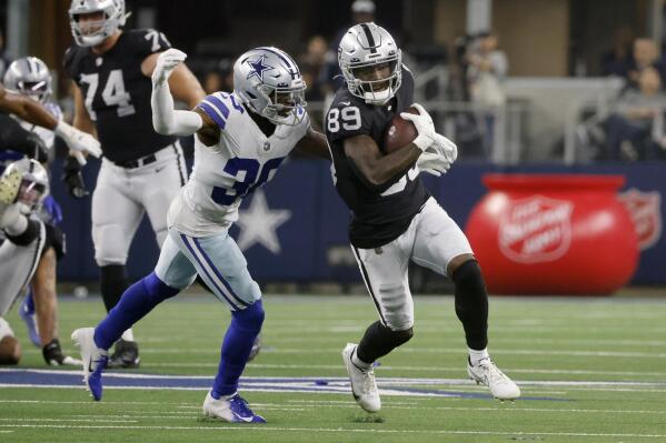 Dallas Cowboys cornerback Anthony Brown (30) moves in to make the stop after Las Vegas Raiders wide receiver Bryan Edwards (89) caught a pass in the first half of an NFL football game in Arlington, Texas, Thursday, Nov. 25, 2021. (AP Photo/Michael Ainsworth)