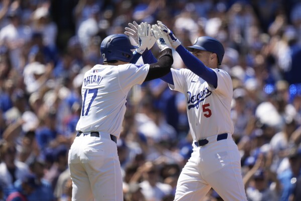 Los Angeles Dodgers' Freddie Freeman (5) celebrates his two-run home run with Shohei Ohtani during the third inning of a baseball game against the St. Louis Cardinals Thursday, March 28, 2024, in Los Angeles. (AP Photo/Jae C. Hong)
