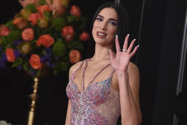 FILE - In this Sunday, March 14, 2021 file photo, Dua Lipa arrives at the 63rd annual Grammy Awards at the Los Angeles Convention Center. Singer Dua Lipa is blasting the organization which paid for a full-page ad in The New York Times that called her antisemitic for her support of Palestinians, saying it used her name “shamelessly” to “advance their ugly campaign with falsehoods and blatant misrepresentations.”  Lipa took to Twitter on Saturday, May 22, 2021 to “reject the false and appalling allegations” and said the World Values Network twisted what she stands for. “I stand in solidarity with all oppressed people and reject all forms of racism,” she wrote. (Photo by Jordan Strauss/Invision/AP, File)