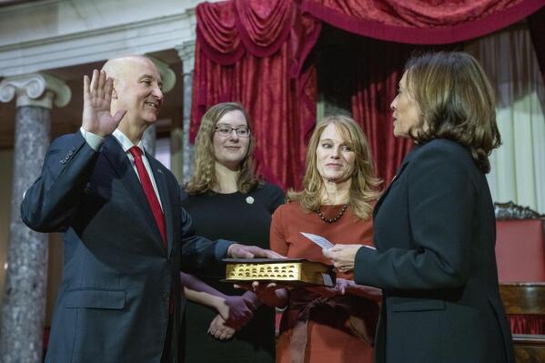 Vice President Kamala Harris participates in a ceremonial swearing-in of Sen. Pete Ricketts, R-Neb., with his daughter Eleanor Ricketts and wife Susanne Shore, Monday, Jan. 23, 2023, on Capitol Hill in Washington. (AP Photo/Jacquelyn Martin)