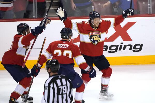 Florida Panthers defenseman Brandon Montour, right, celebrates after scoring in overtime of the team's NHL hockey game against the Toronto Maple Leafs, Saturday, April 23, 2022, in Sunrise, Fla. The Panthers won 3-2. (AP Photo/Lynne Sladky)