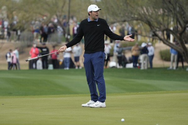 Scottie Scheffler reacts to missing an eagle putt attempt on the 15th hole during the second round of the Phoenix Open golf tournament Friday, Feb. 9, 2024, in Scottsdale, Ariz. (AP Photo/Ross D. Franklin)
