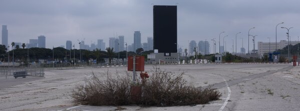 In this Thursday, April 16, 2020 photo, an advertising billboard covered in black during lockdown following government measures to help stop the spread of the coronavirus in Tel Aviv, Israel. The once thrumming city of Tel Aviv, famed for its nightlife and bustling beachfront, has fallen eerily quiet due to Israel's tight movement restrictions to halt the spread of the coronavirus. (AP Photo/Oded Balilty)