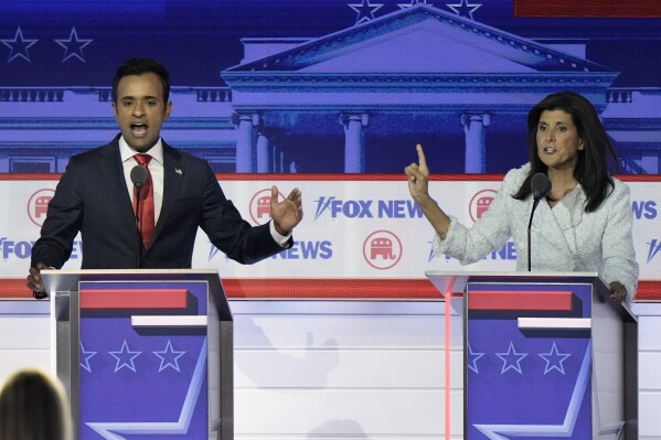 FILE - Businessman Vivek Ramaswamy, left, and former U.N. Ambassador Nikki Haley speak during a Republican presidential primary debate hosted by FOX News Channel, Aug. 23, 2023, in Milwaukee. Ramaswamy and Haley, two of the leading contenders for the Republican presidential nomination, are Indian Americans, even though polling points to an Indian diaspora that overwhelmingly votes Democrat. The two candidates are running significantly behind former President Donald Trump and also trail Florida Gov. Ron DeSantis, but they’re outpacing others in the field. (AP Photo/Morry Gash, File)