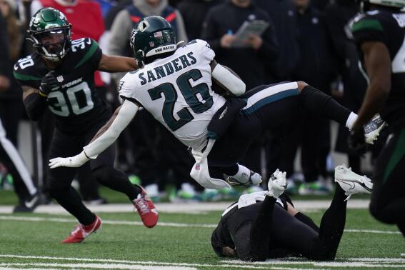 Philadelphia Eagles running back Miles Sanders (26) leaps for extra yardage on a running play during the first half of an NFL football game against the New York Jets, Sunday, Dec. 5, 2021, in East Rutherford, N.J. (AP Photo/Seth Wenig)