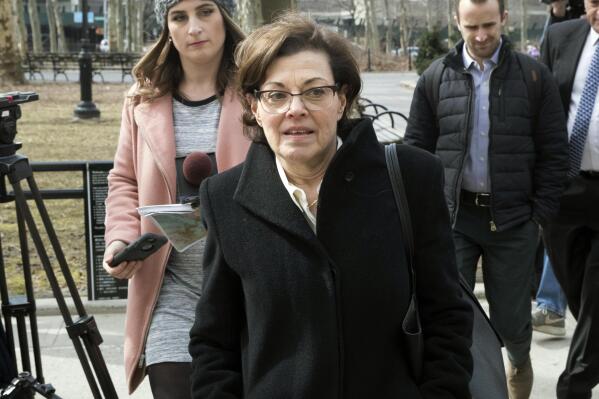 FILE — In this March 13, 2019 file photo, Nancy Salzman, center, arrives at Brooklyn federal court, in New York. Salzman, the former president and co-founder of NXIVM, was sentenced Wednesday, Sept. 8, 2021, to 42 months in prison and fined $150,000, but won't be locked up until January. (AP Photo/Mary Altaffer, File)
