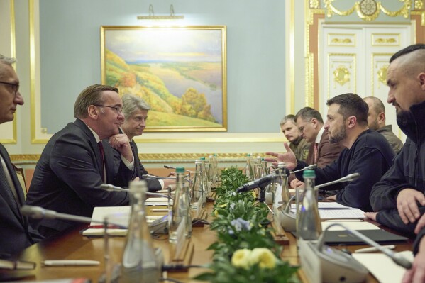 In this photo provided by the Ukrainian Presidential Press Office, Ukrainian President Volodymyr Zelenskyy, second right, and Germany's Defense Minister Boris Pistorius talk during their meeting in Kyiv, Ukraine, Tuesday, Nov. 21, 2023. (Ukrainian Presidential Press Office via AP)